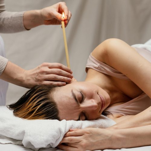 close-up-therapist-using-candle-ear